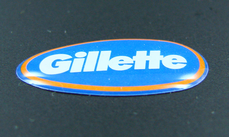 Blaues Doming Etikett mit Aufschrift "Gillette"